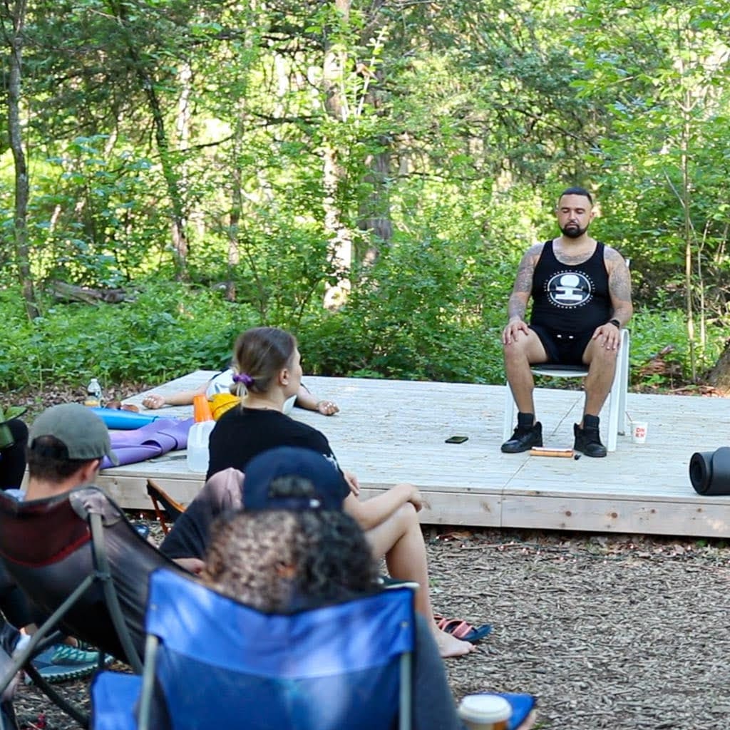 People in breathwork, amber light and blankets
