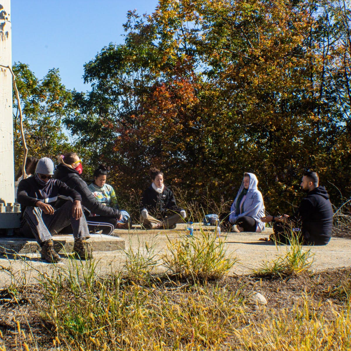 Eddie leading outdoor session on wooden platform